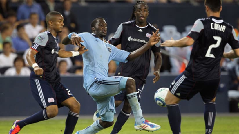 C.J. Sapong controls the ball while New England's Darrius Barnes and Shalrie Joseph look on