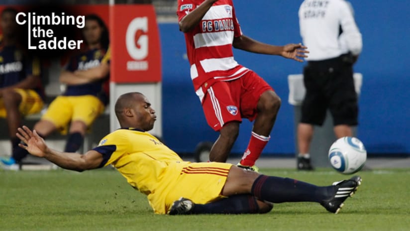 Climbing the Ladder: RSL's Jamison Olave slides tackles the ball away from an FC Dallas attacker.
