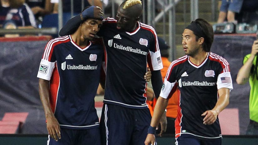 New England's Jerry Bengtson is congratulated by Saer Sene and Lee Nguyen after scoring against New York, July 8, 2012.