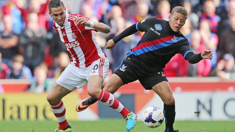 Geoff Cameron, Stoke City, battles Crystal Palace's Dwight Gayle for a loose ball.