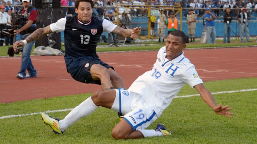 Honduras' Luis Garrido tackles USMNT's Jermaine Jones