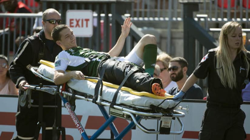 Portland Timbers captain Will Johnson is carted off the field in Toronto after suffering a broken leg