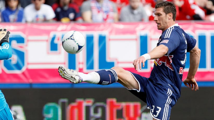New York's Kenny Cooper chips the ball over FC Dallas GK Kevin Hartman