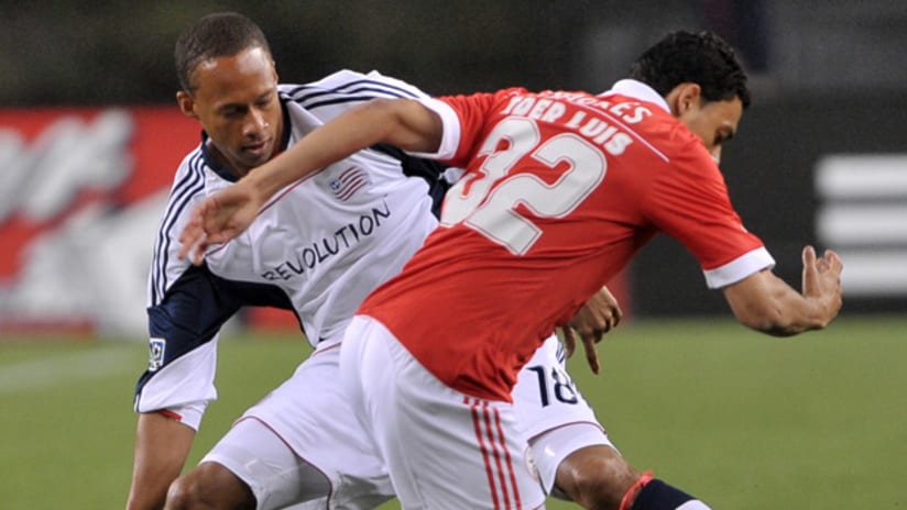 Khano Smith battles with Benfica in the Revolution's 4-0 loss to the Portuguese champions.