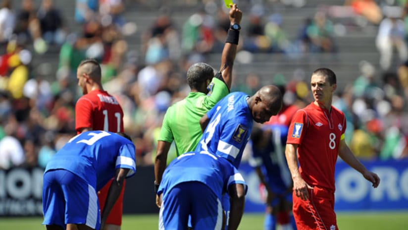 Canada's Will Johnson is shown a yellow card in the Gold Cup loss to Martinique.