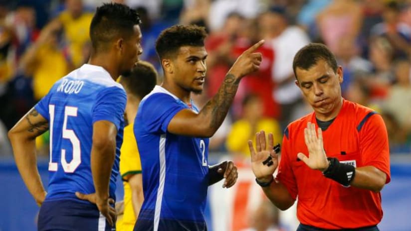Michael Orozco, DeAndre Yedlin (USMNT) try to chat up a referee