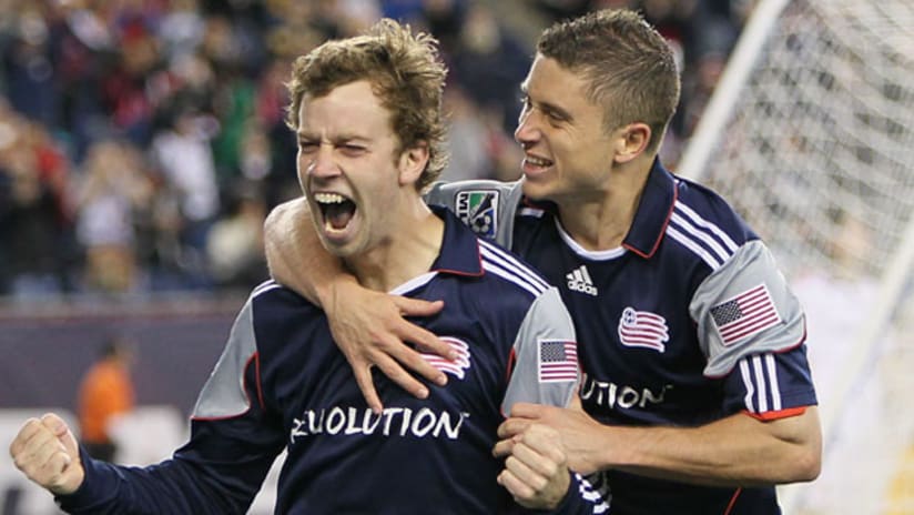 New England's Zack Schilawski (left) celebrates his first goal with teammate Chris Tierney at Gillette Stadium in Foxboro, Mass.