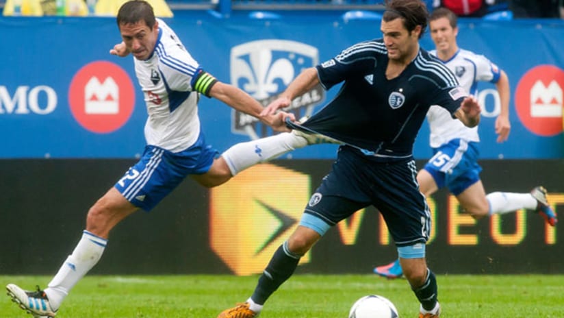 Montreal's Davy Arnaud tussles with Sporting KC's Graham Zusi