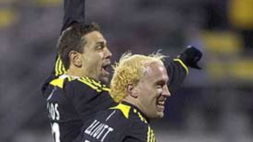 Manny Lagos and Simon Elliott celebrate one of the Crew's three goals.