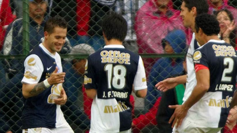 Jose Francisco Torres and Mauro Cejas celebrate their win over Toluca.