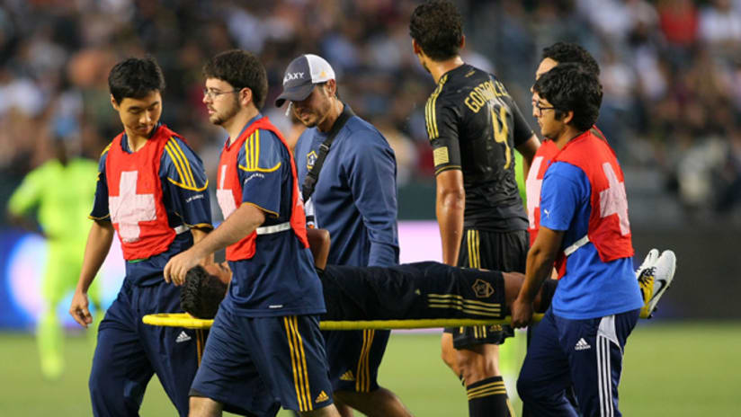 AJ DeLaGarza is carried off the field during the LA Galaxy's game against the Seattle Sounders on Monday.