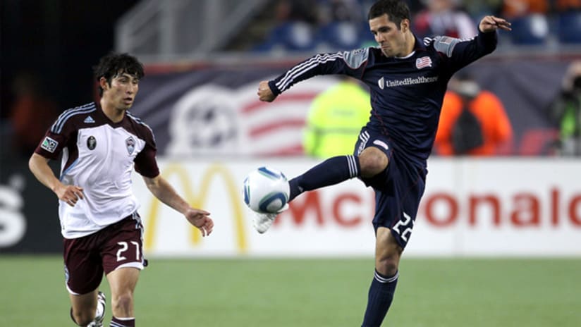 New England's Benny Feilhaber connects the ball as Colorado's Kosuke Kimura watches on.