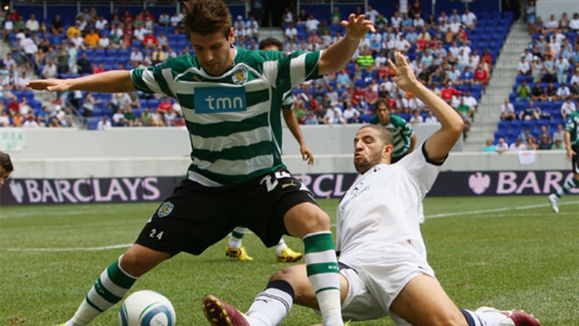 Sporting's Miguel Veloso (left) avoids the tackle of Tottenham's Adel Taarabt on Sunday at Red Bull Arena.
