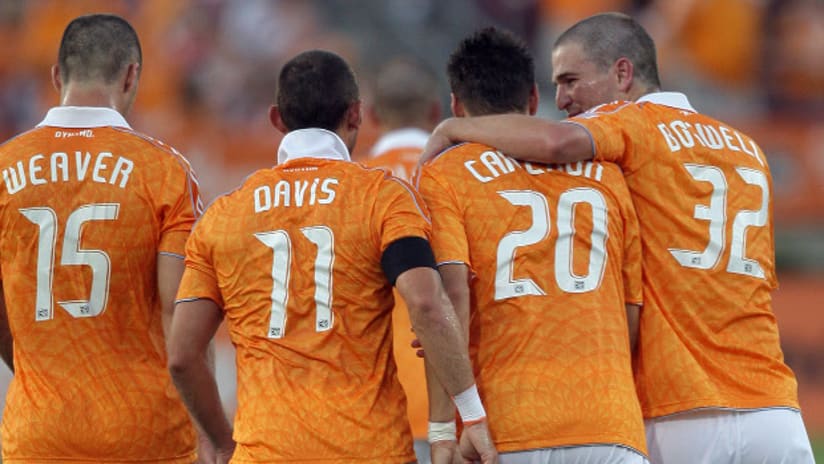 Bobby Boswell, Geoff Cameron, Brad Davis, and Cam Weaver of the Houston Dynamo celebrate after a goal.