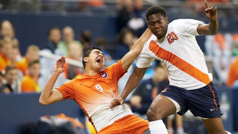 Clemson Tigers forward Diego Campos and Syracuse Orange defender Kamal Miller battle for the ball