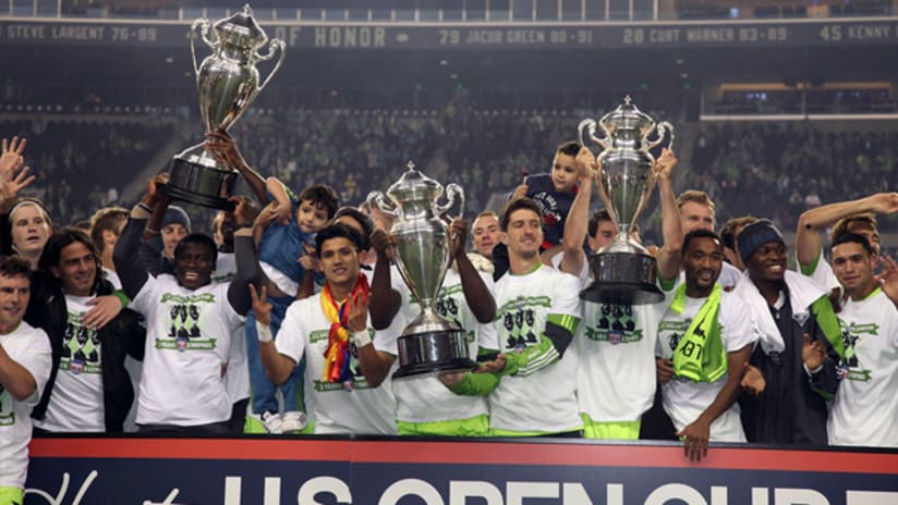 Seattle Sounders players lift up all three US Open Cup trophies