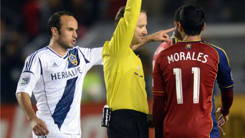 LA's Landon Donovan gestures while official Kevin Stott gives a yellow card; Real Salt Lake's Javier Morales looks on