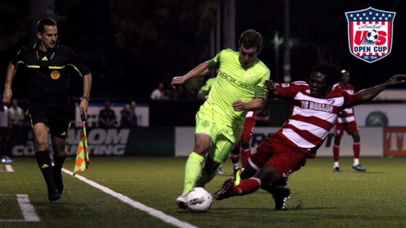 Seattle's Mike Fucito tries to get by a sliding Ugo Ihemelu of FC Dallas during USOC play.