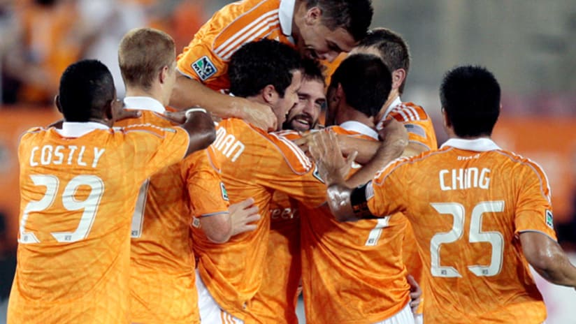 Houston midfielder Adam Moffat is surrounded by his teammates after scoring a goal vs. Portland.