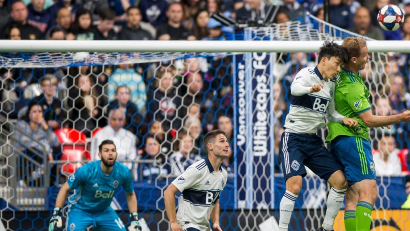 Vancouver Whitecaps and Seattle Sounders battle for header