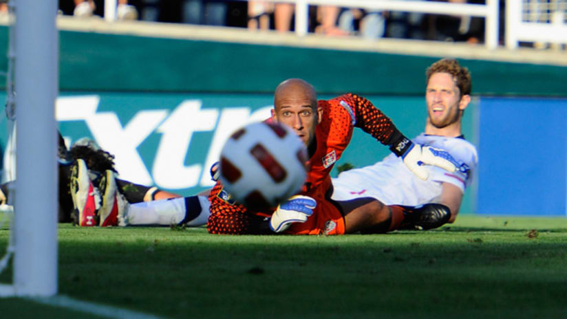 Tim Howard and Clarence Goodson watch Gio Dos Santos' shot drift wide
