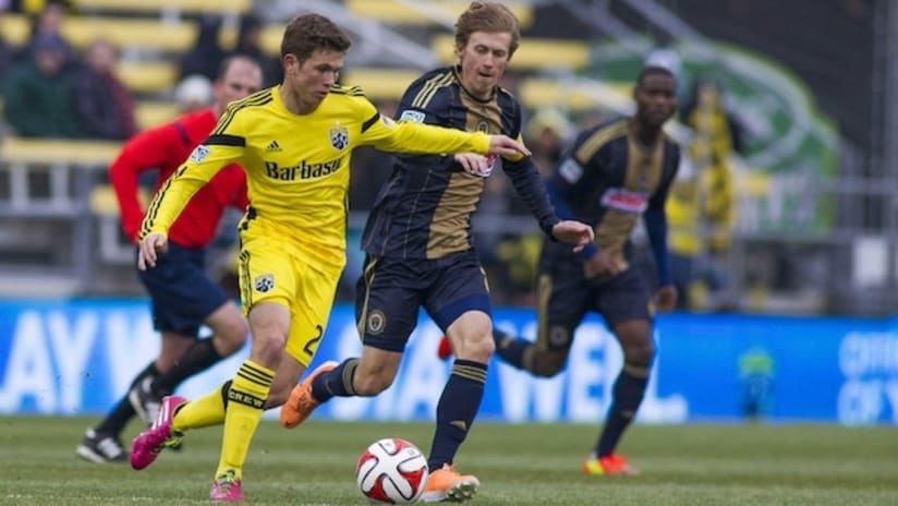 Wil Trapp takes the ball past Brian Carroll
