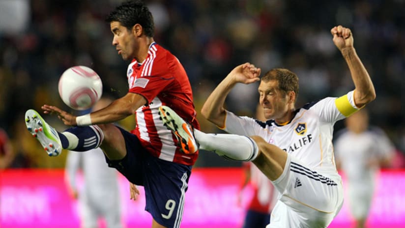 Chivas USA's Juan Pablo Angel goes up for a ball against Galaxy's Gregg Berhalter