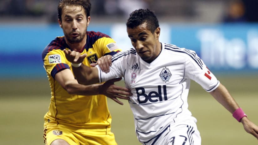 Vancovuer's Camilo (right) speeds by RSL's Ned Grabavoy