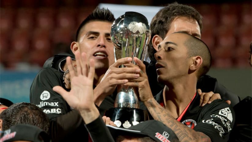 Joe Corona and Edgar Castillo lift the Liga MX trophy