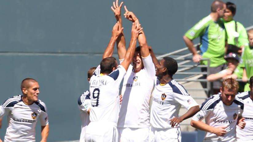 Omar Gonzalez, center, is mobbed by teammates after scoring his first goal of the season.
