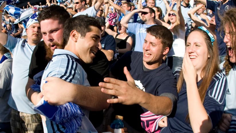 Soony Saad embraces the Sporting Kansas City fans after Sporting clinched a playoff berth win on Saturday.
