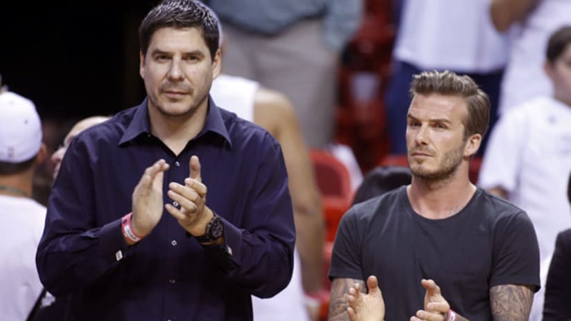 Marcelo Claure and David Beckham during a Miami Heat game