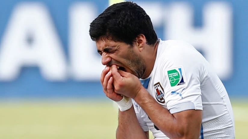 Luis Suarez massages his teeth (June 24, 2014)