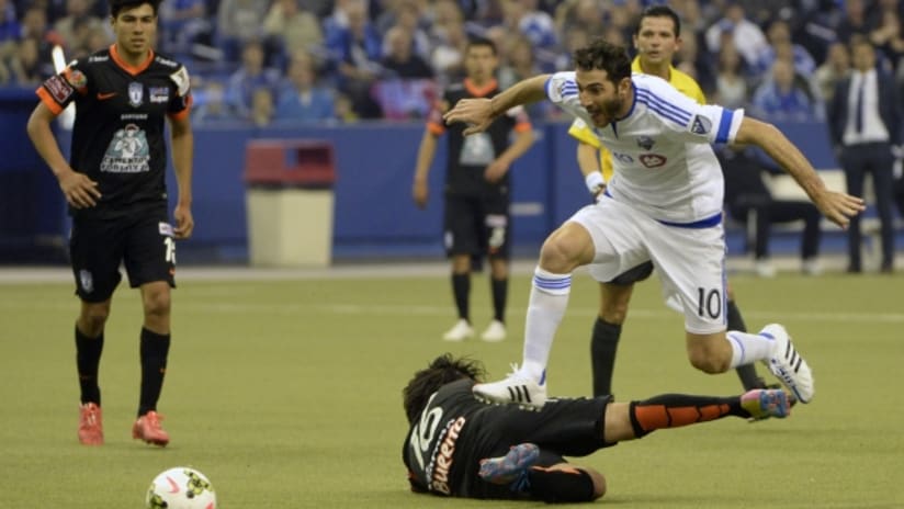 Montreal Impact midfielder Ignacio Piatti tries to avoid a Pachuca tackle in Champions League play