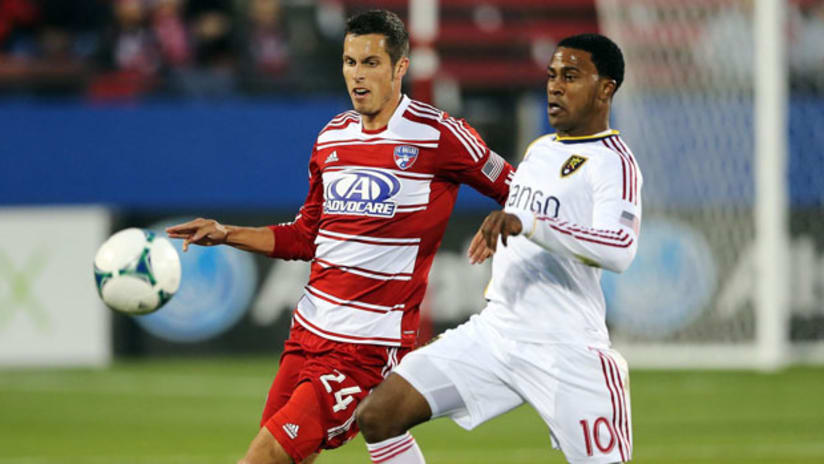 FC Dallas's Matt Hedges and Real Salt Lake's Robbie Findley chase a loose ball.