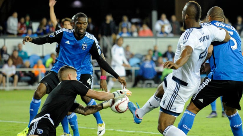 David Bingham makes the save as San Jose Earthquakes mele with Vancouver Whitecaps in penalty area