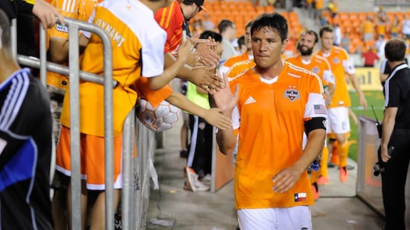 Brian Ching high fives the fans