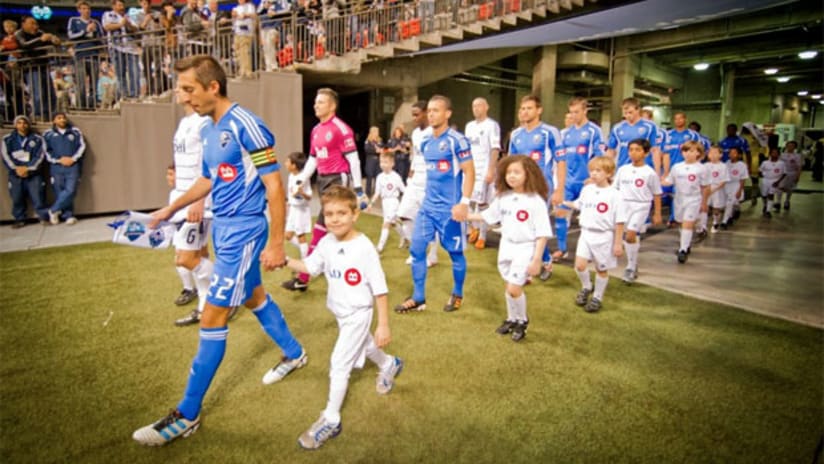 Davy Arnaud leads the Impact onto the pitch at BC Place
