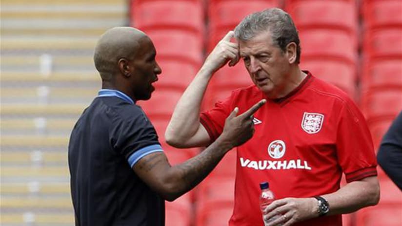 Jermain Defoe and Roy Hodgson talk to each other, England