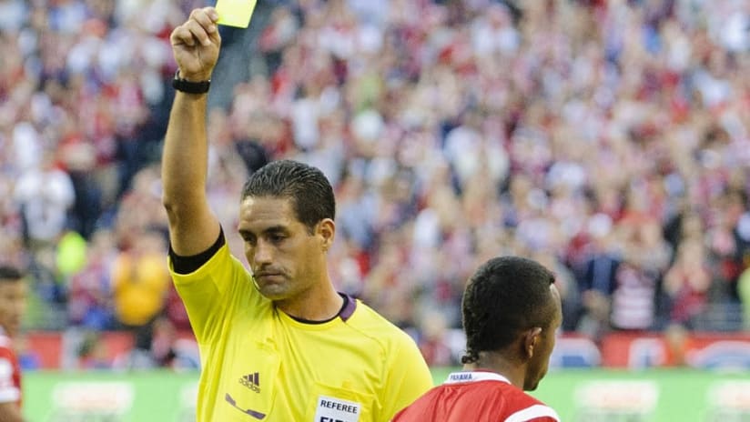 USA vs. Colombia referee Roberto Garcia gives a yellow to a Panama player in 2013