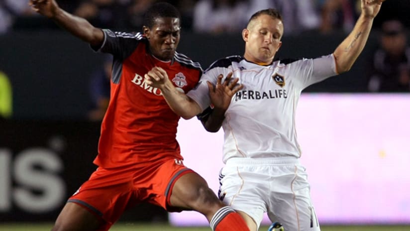 Toronto's Doneil Henry and Galaxy's Chad Barrett vie for possession.
