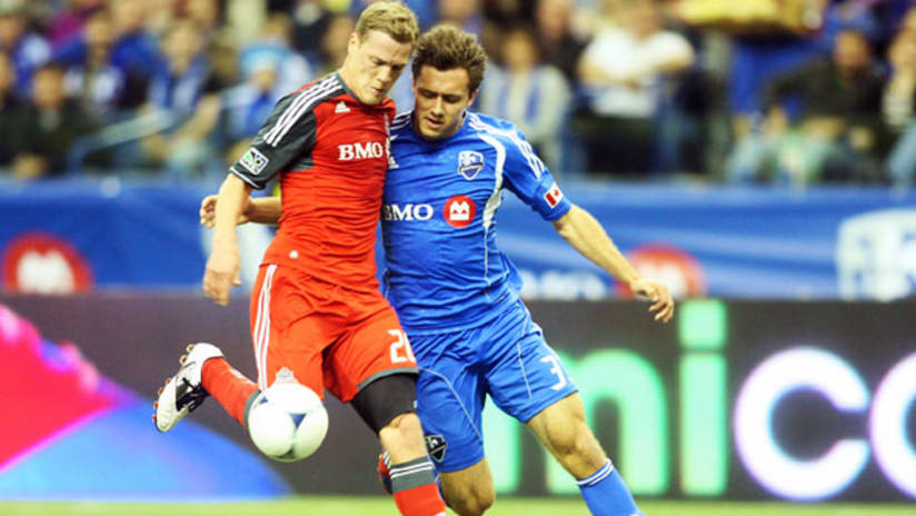 Toronto FC's Ty Harden holds off Montreal Impact's Andrew Wenger, April 7, 2012.