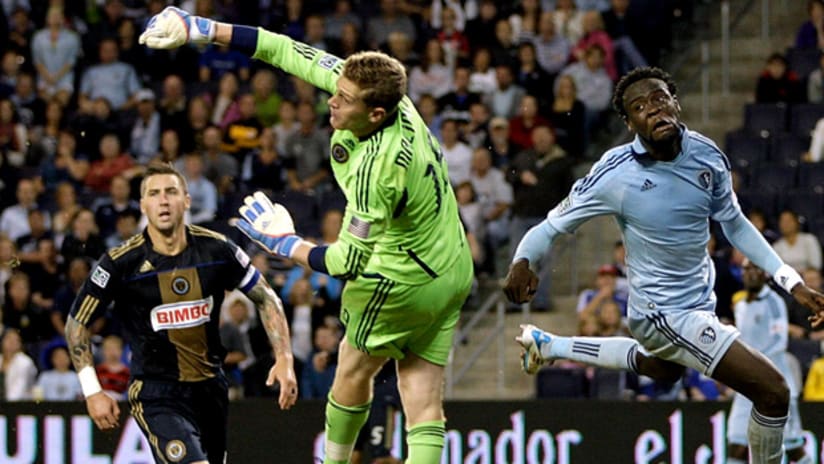 Union 'keeper Zac MacMath punches out a cross as Danny Califf and SKC's Kei Kamara watch on.