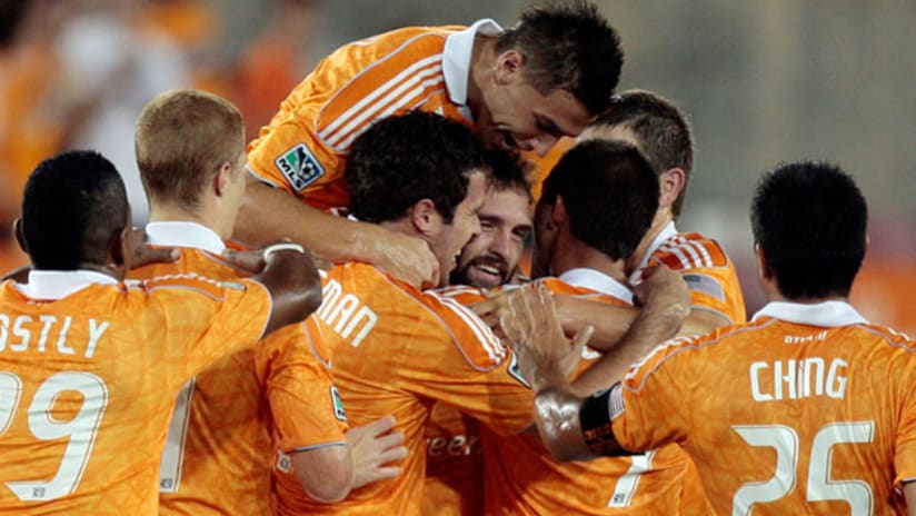 Houston Dynamo players celebrate a goal from Adam Moffat (center) on Aug. 14.