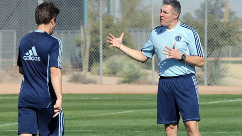 Sporting KC head coach Peter Vermes gives instructions to one of his players.