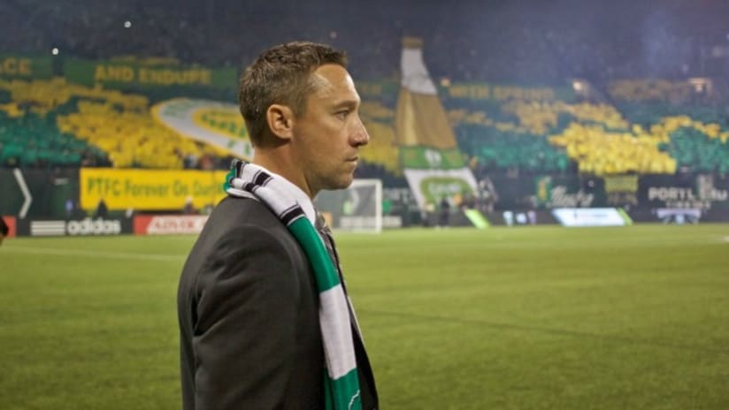Portland Timbers coach Caleb Porter with Timbers Army tifo in background, March 7, 2015