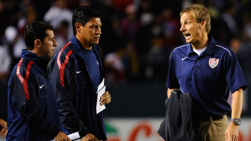 Jurgen Klinsmann talks with his assistants Martin Vasquez and Tab Ramos after the US lost 1-0 to Costa Rica