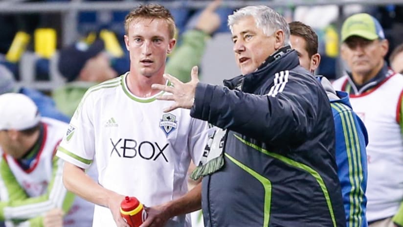 Dylan Remick and Sigi Schmid talk things over during a Seattle Sounders match