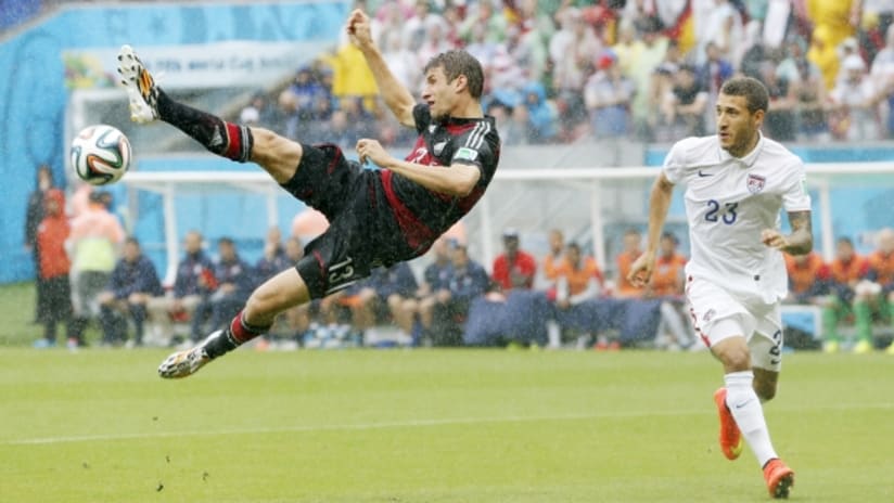 Thomas Muller tries acrobatics against Fabian Johnson