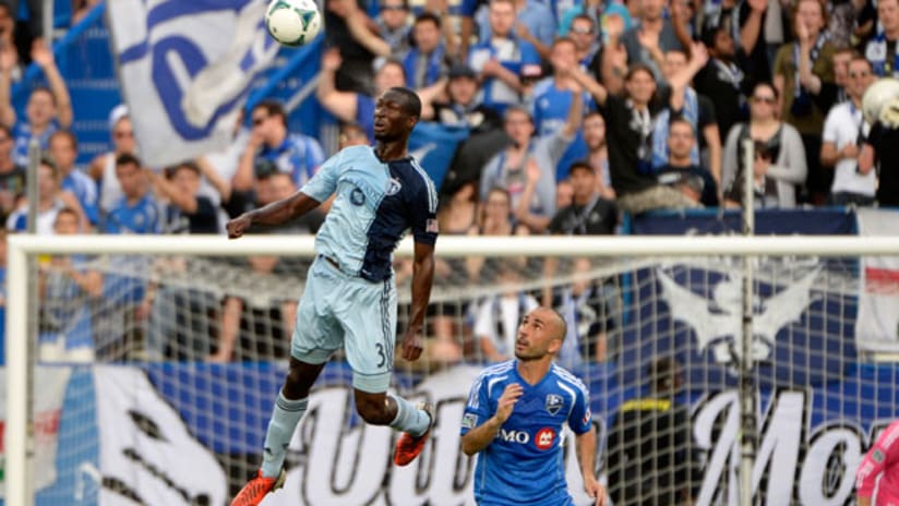 Ike Opara clears away from Marco Di Vaio in MTLvSKC
